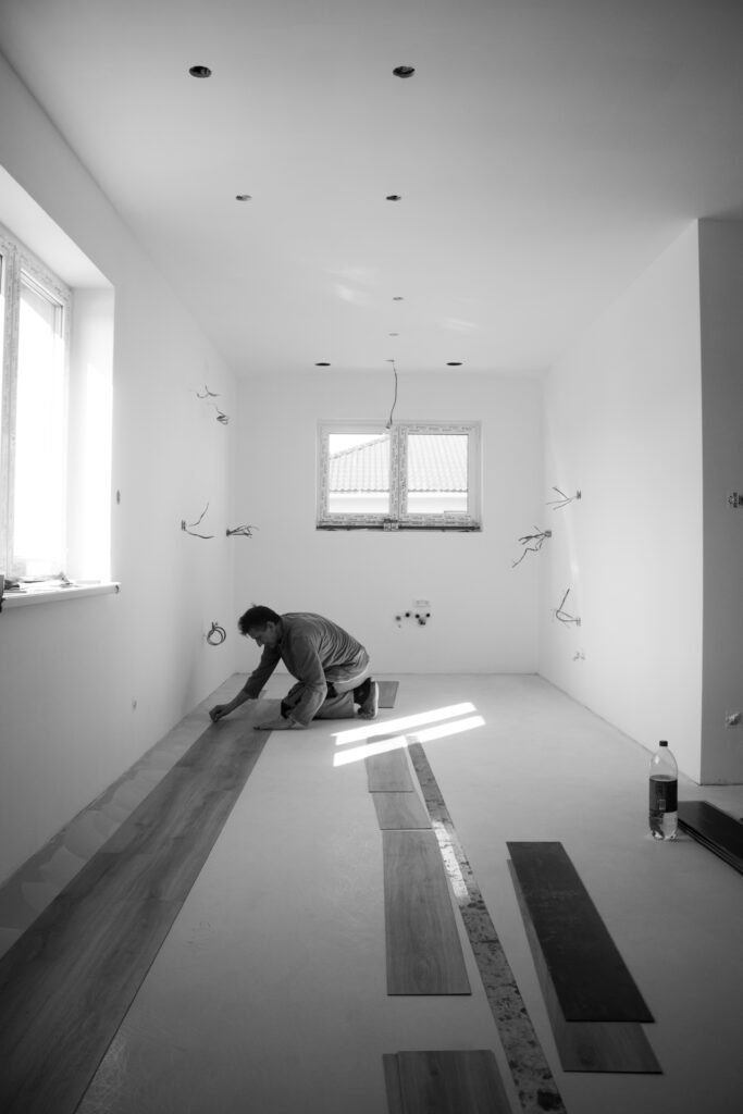 A man perfectly removing the laminate flooring.